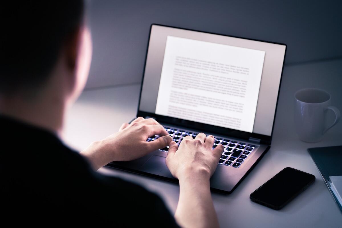 Writer creating a journal on a laptop.