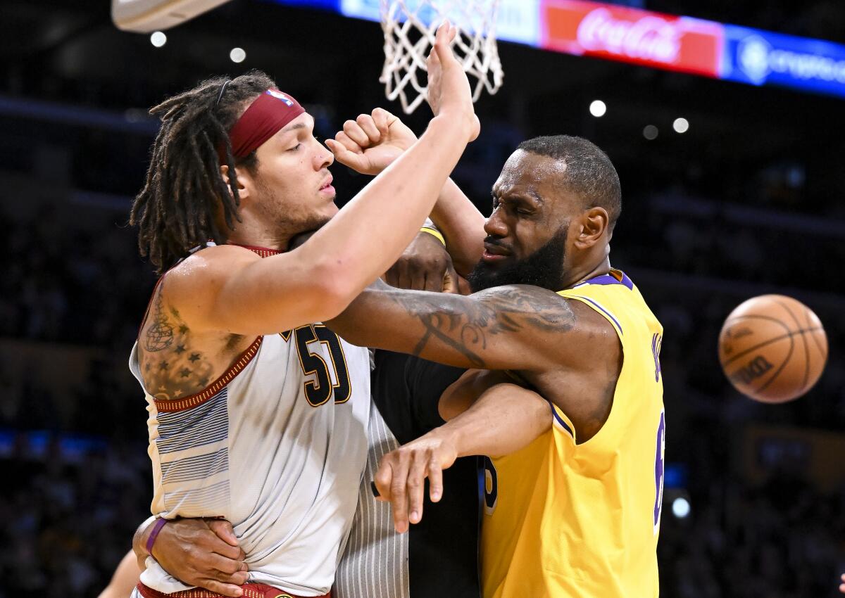 Lakers forward LeBron James, right, and Nuggets forward Aaron Gordon get into a shoving match during Game 4.