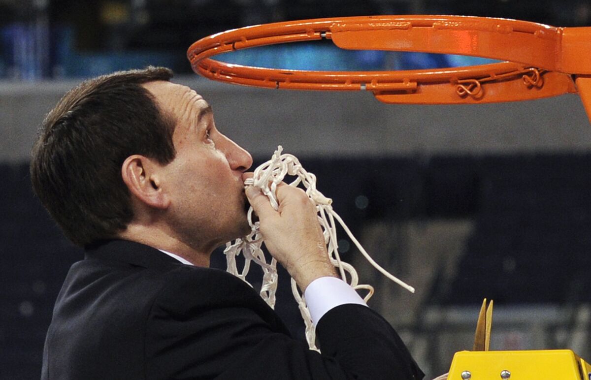 FILE - Duke head coach Mike Krzyzewski kisses the net after cutting it down following Duke's 61-59 win over Butler in the men's NCAA Final Four college basketball championship game Monday, April 5, 2010, in Indianapolis. Krzyzewski's unparalleled coaching career is down to a few basketball games, with no more than a month left before the retiring Duke Hall of Famer walks off the sideline for the last time. (AP Photo/Mark J. Terrill, File)