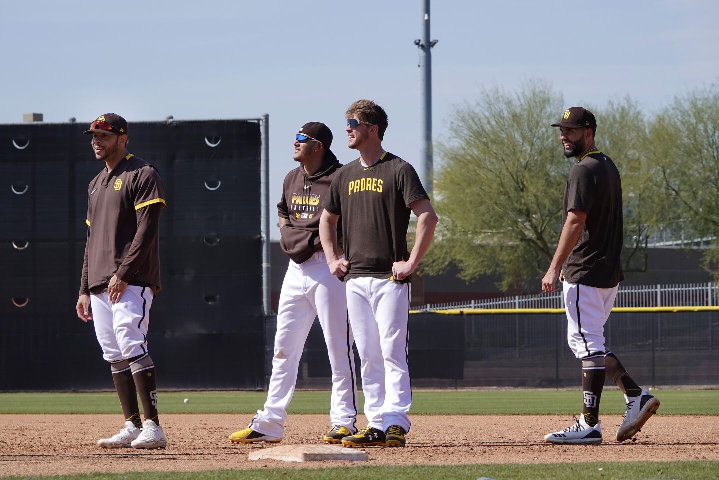 San Diego Padres Tommy Pham, Manny Machado, Wil Myers and Eric Hosmer look on during a spring training practice on Feb. 18, 2020.