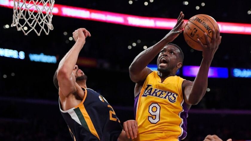 Lakers forward Luol Deng drives to hoop against Utah center Rudy Gobert during a game on Dec. 27.