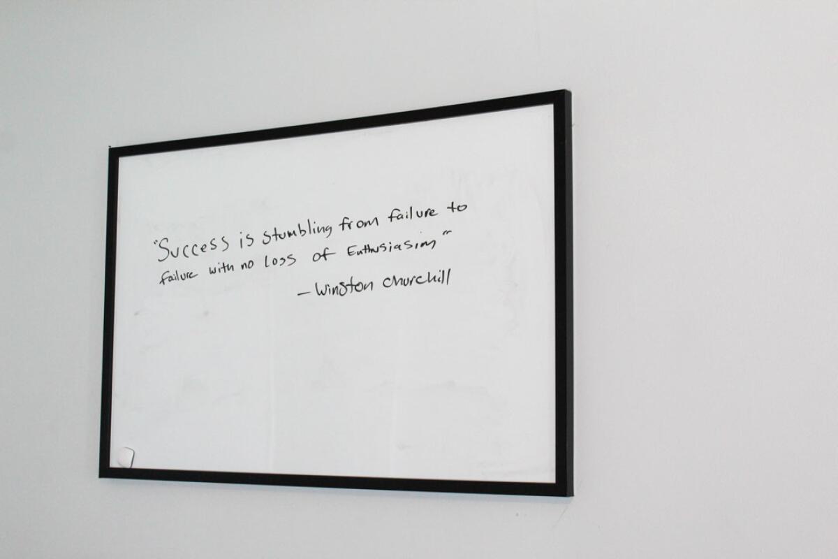 A framed quotation reads, "Success is stumbling from failure to failure with no loss of enthusiasm."