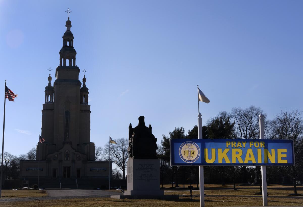A sign outside St. Andrew Ukrainian Orthodox Memorial Church in South Bound Brook, N.J., reads, "Pray for Ukraine," Wednesday, Feb. 9, 2022. Religious leaders and members of the Ukrainian diaspora in the United States are growing increasingly alarmed over the threat of a Russian invasion to Ukraine and have stepped efforts to help their family members back home. (AP Photo/Luis Andres Henao)