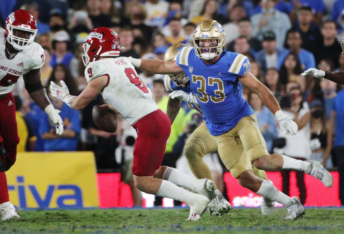 UCLA linebacker Bo Calvert (33) has his eyes on Fresno State quarterback Jake Haener (9) on Sept. 18, 2021.