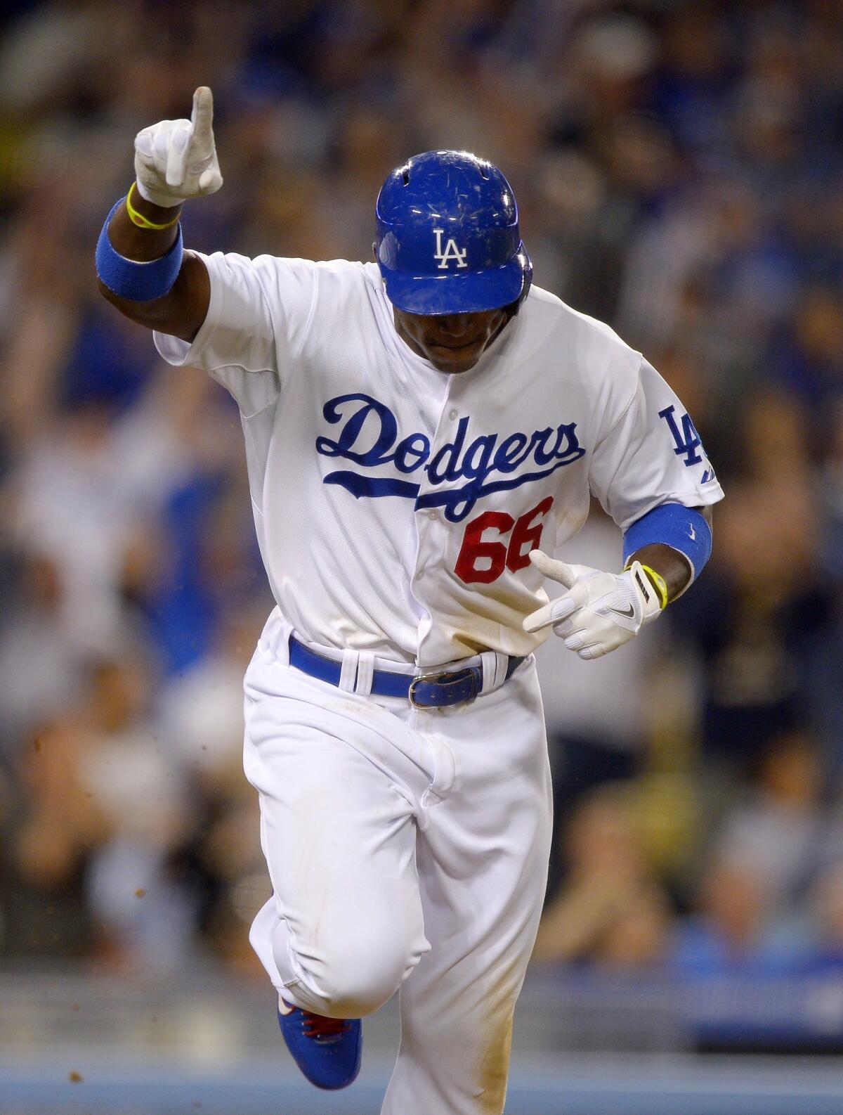 Dodgers right fielder Yasiel Puig gestures after hitting a run-scoring single during the eighth inning of the Dodgers' 3-2 victory over the San Francisco Giants on Monday.