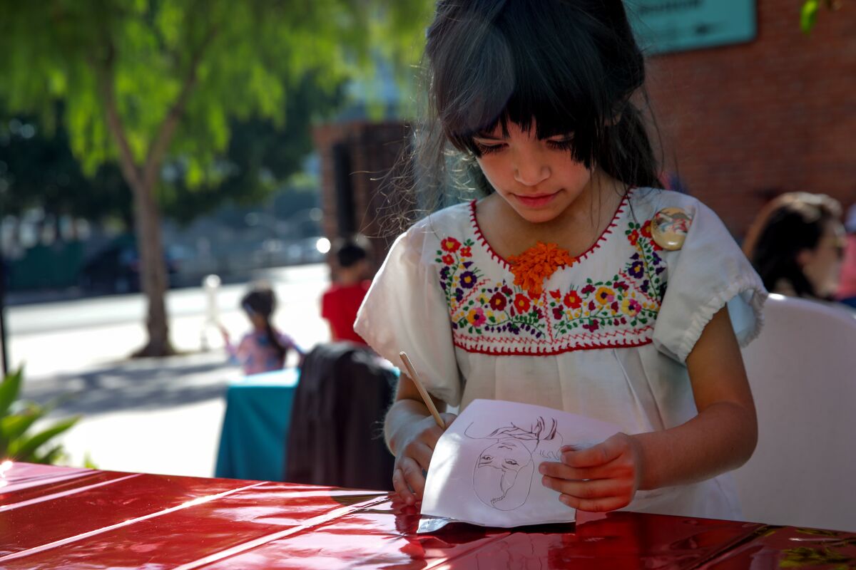 A girl draws on artwork