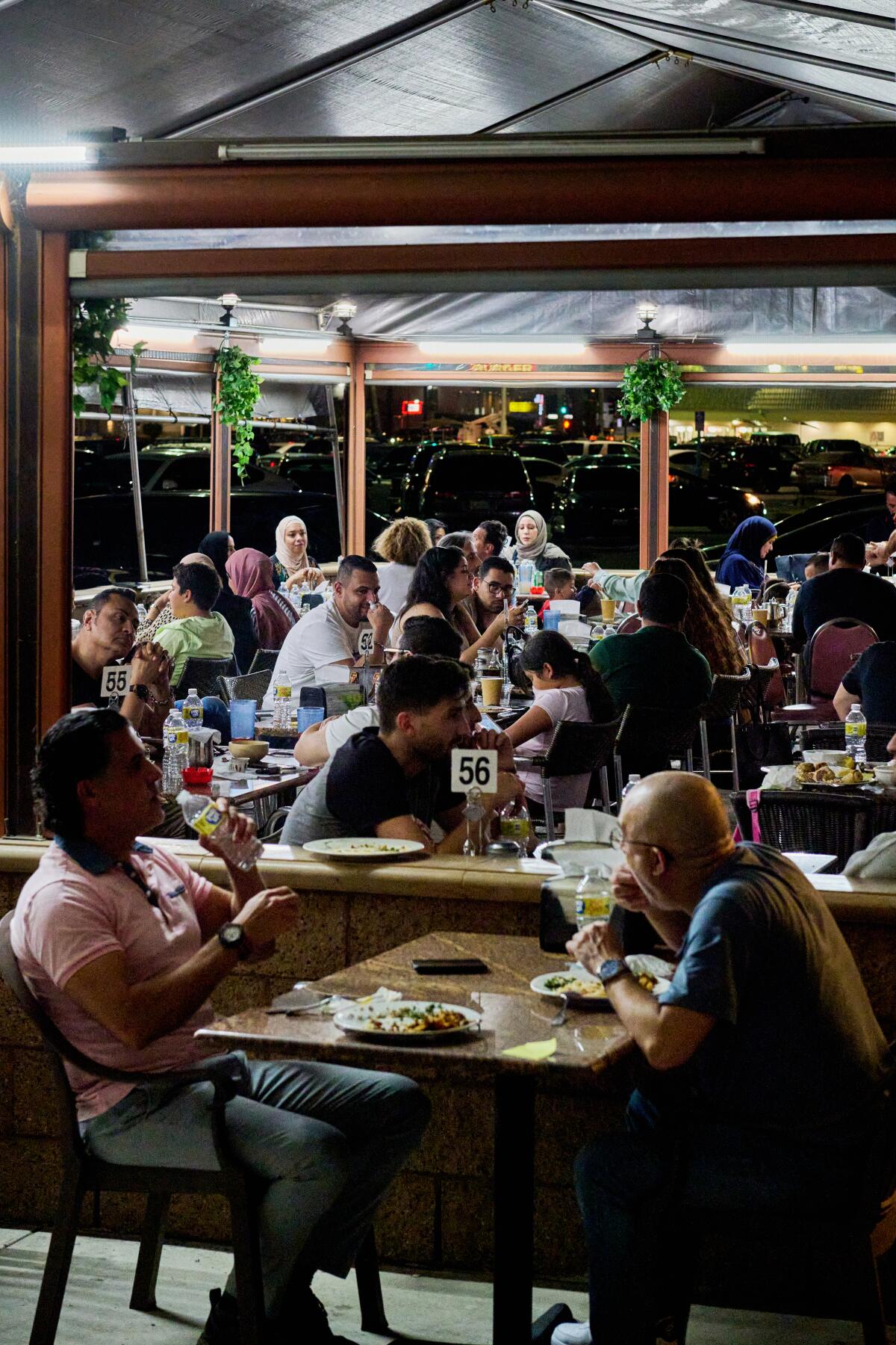 Diners seated under a large tent outside breaking their fast with the Iftar buffet at Little Arabia.