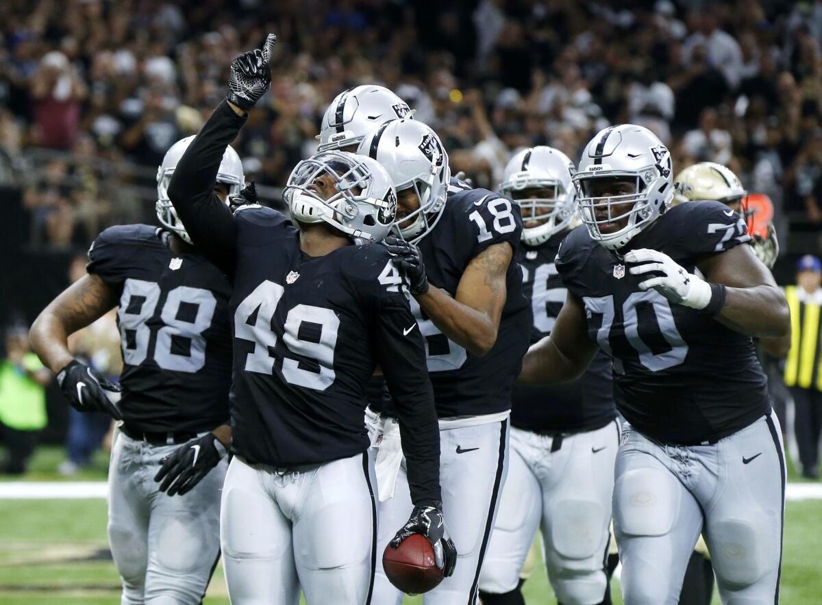 Oakland Raiders running back Jamize Olawale (49) and his teammates celebrate a touchdown Sunday in New Orleans.