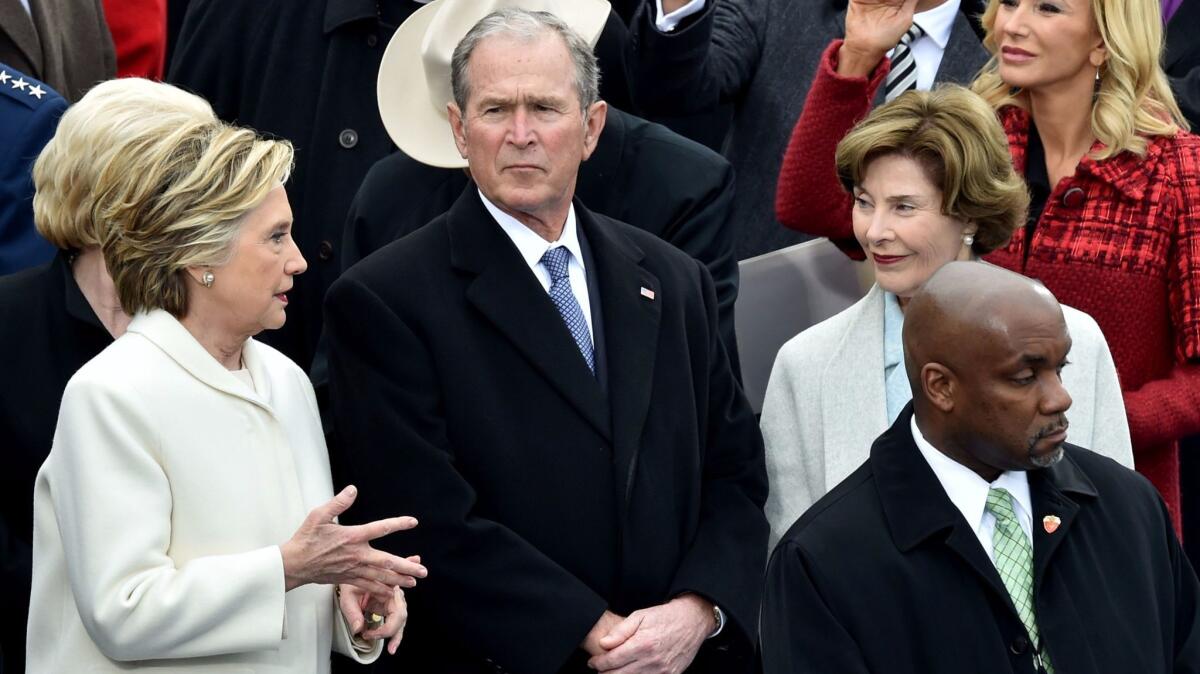 Former Secretary of State Hillary Clinton, left, speaks to former President George W. Bush and his wife, Laura Bush, before the presidential inauguration in Washington on Friday.