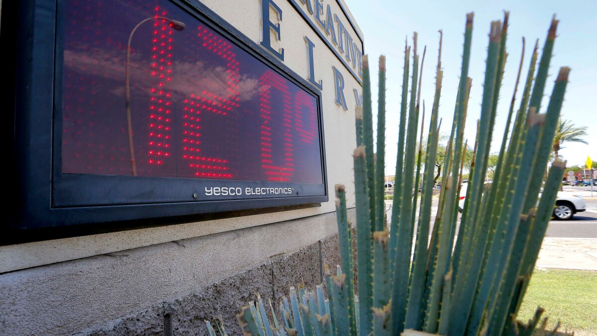 Sign indicates the temperature in Phoenix on a June day.