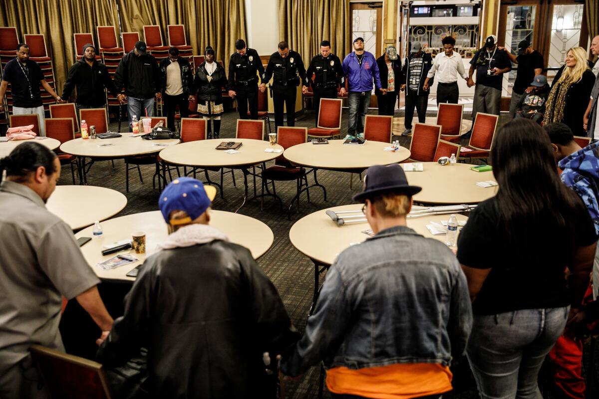 Participants gather for a prayer at the end of a Cease Fire meeting in Los Angeles on April 3.