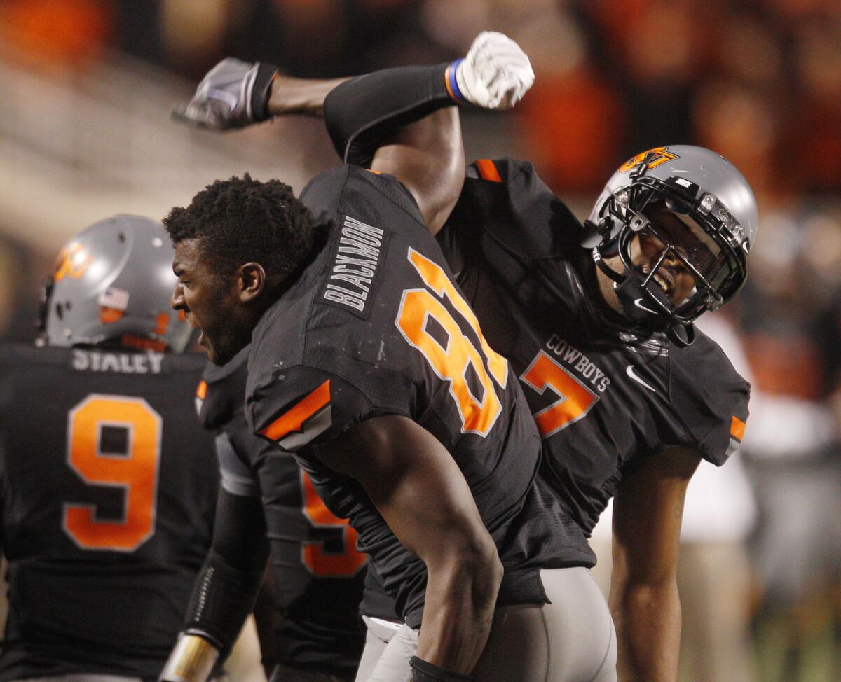 Oklahoma State wide receiver Justin Blackmon, left, celebrates with teammate Michael Harrison in 2011.