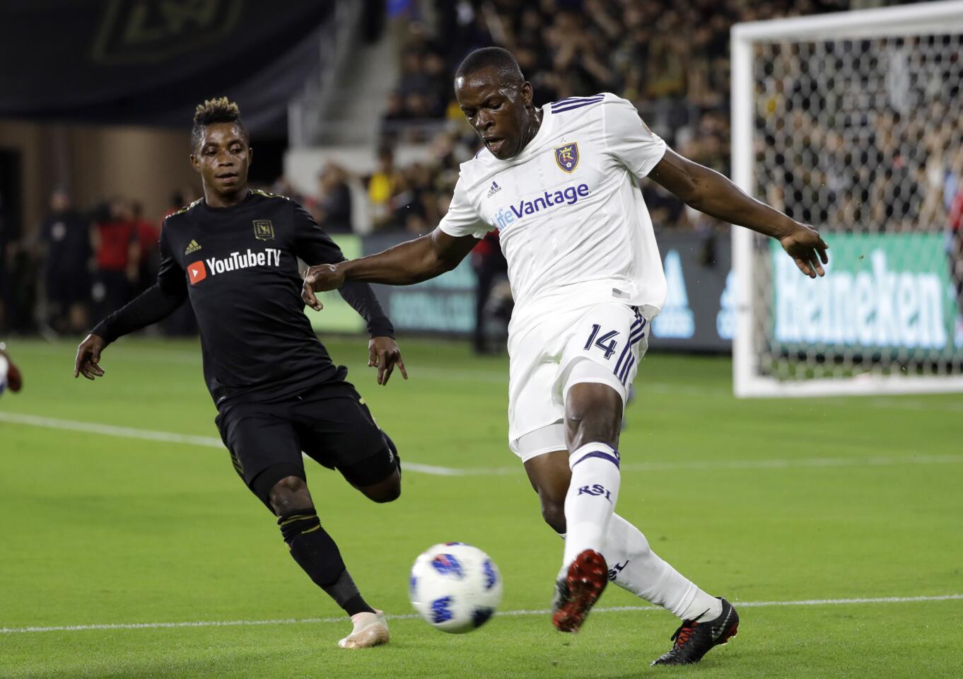 Real Salt Lake's Nedum Onuoha, right, clears the ball as Los Angeles FC's Latif Blessing closes in during the first half of an MLS soccer playoff match Thursday, Nov. 1, 2018, in Los Angeles. (AP Photo/Marcio Jose Sanchez)