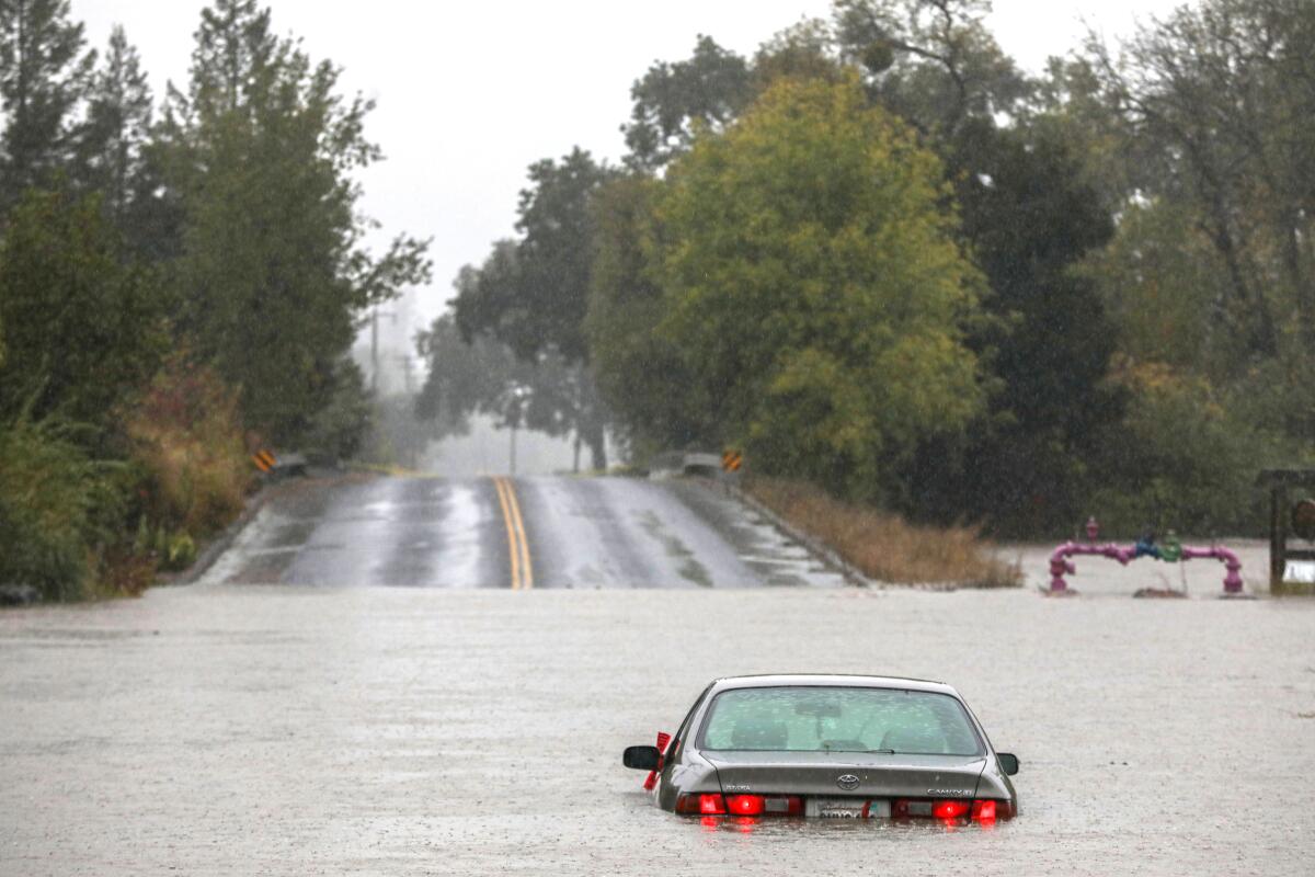 A vehicle sits in flood waters