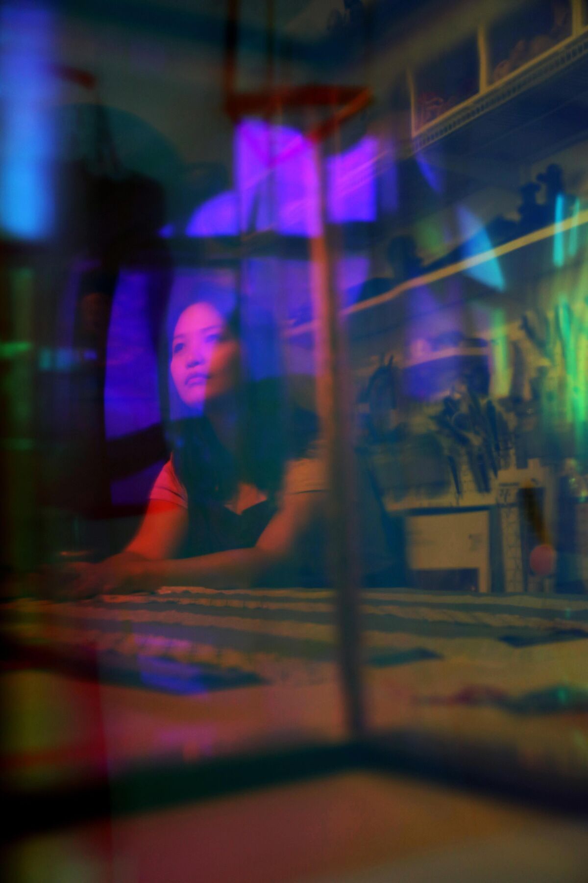 An image of a woman overlaid with colorful lights