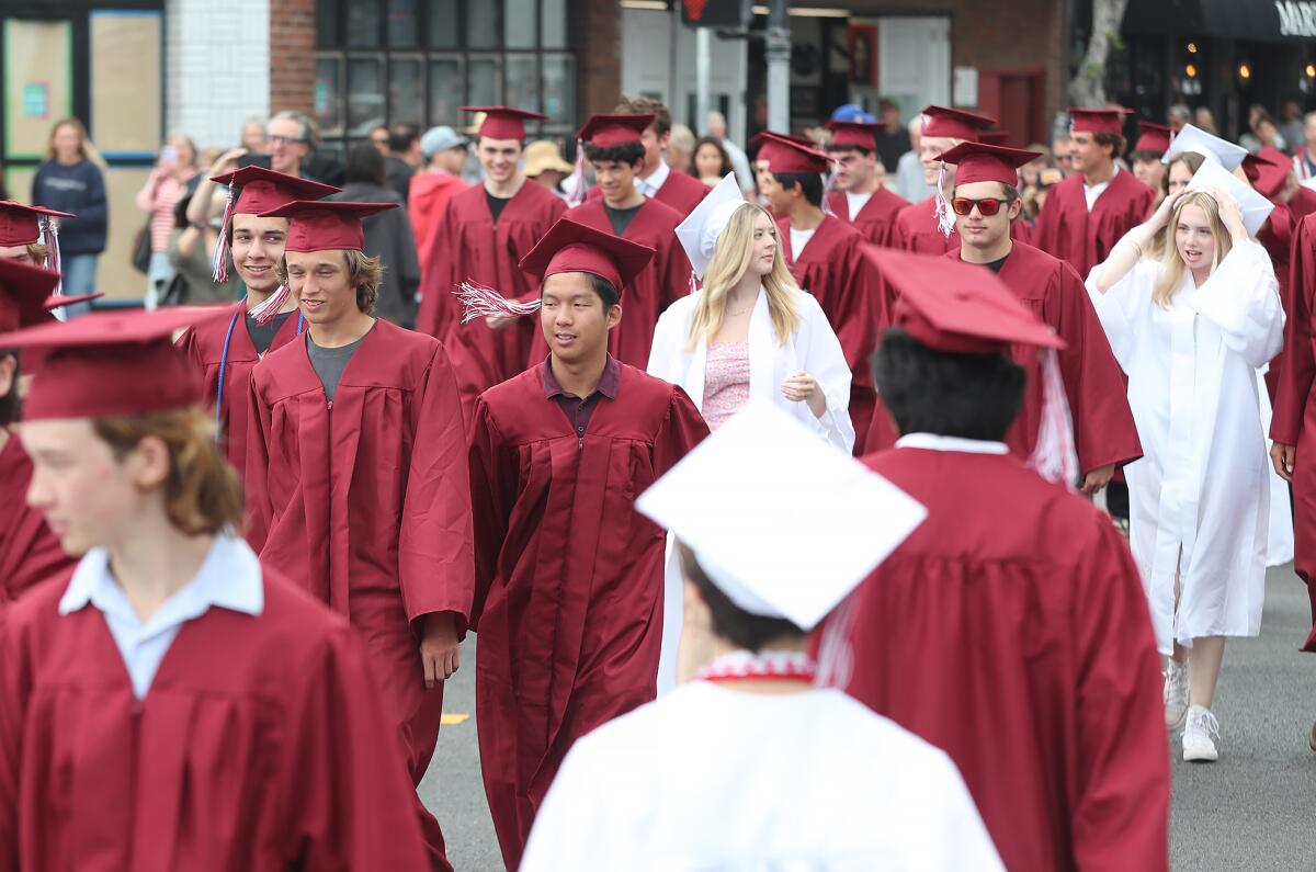 Laguna Beach High seniors participate in a celebratory parade down Ocean Avenue on Tuesday.