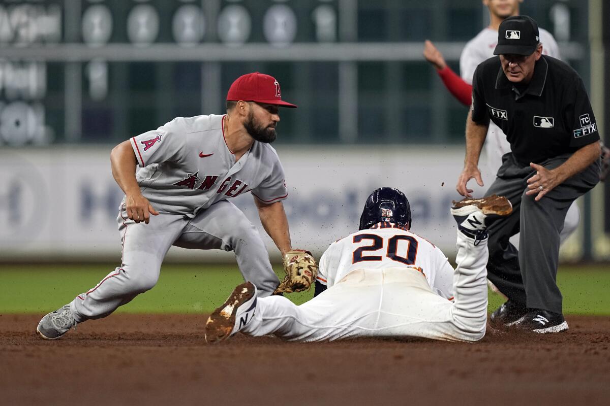 Houston Astros' Chas McCormick is tagged out by Angels second baseman Jack Mayfield while trying to steal second base.