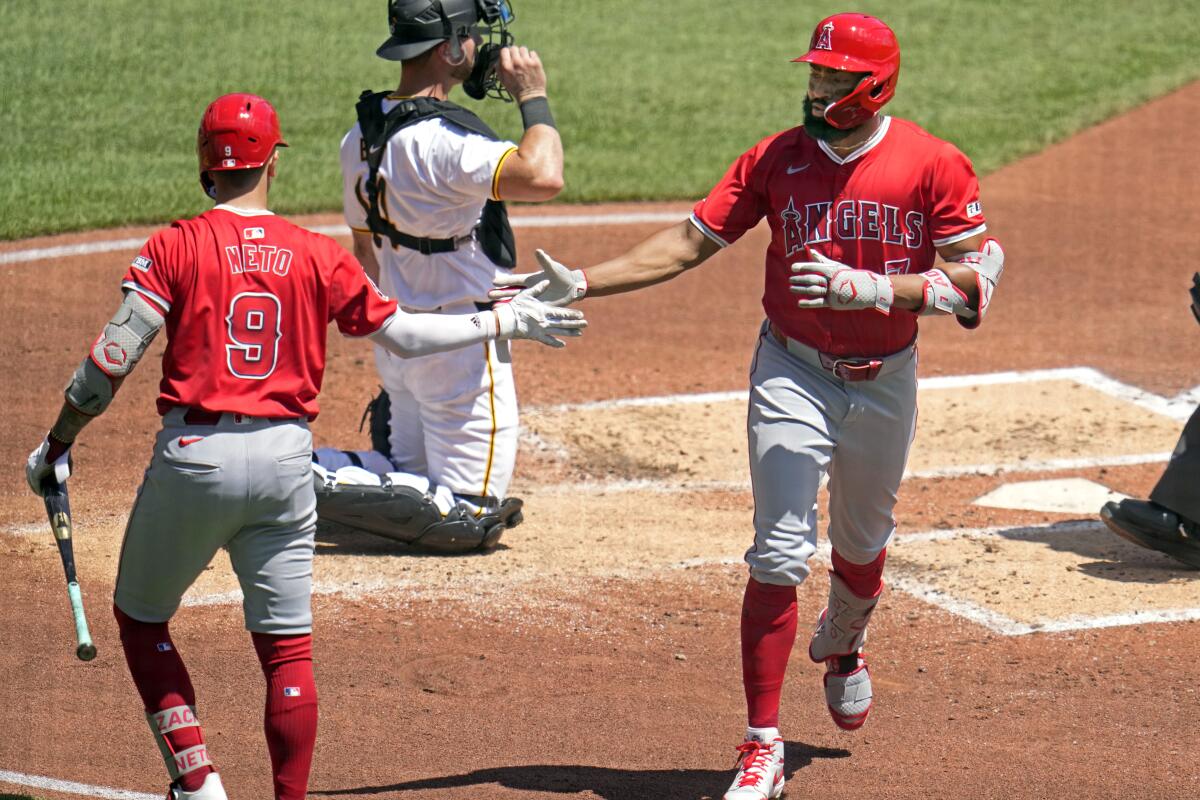 The Angels' Jo Adell, right, is greeted by Zach Neto after hitting a solo home run during the third inning Wednesday.