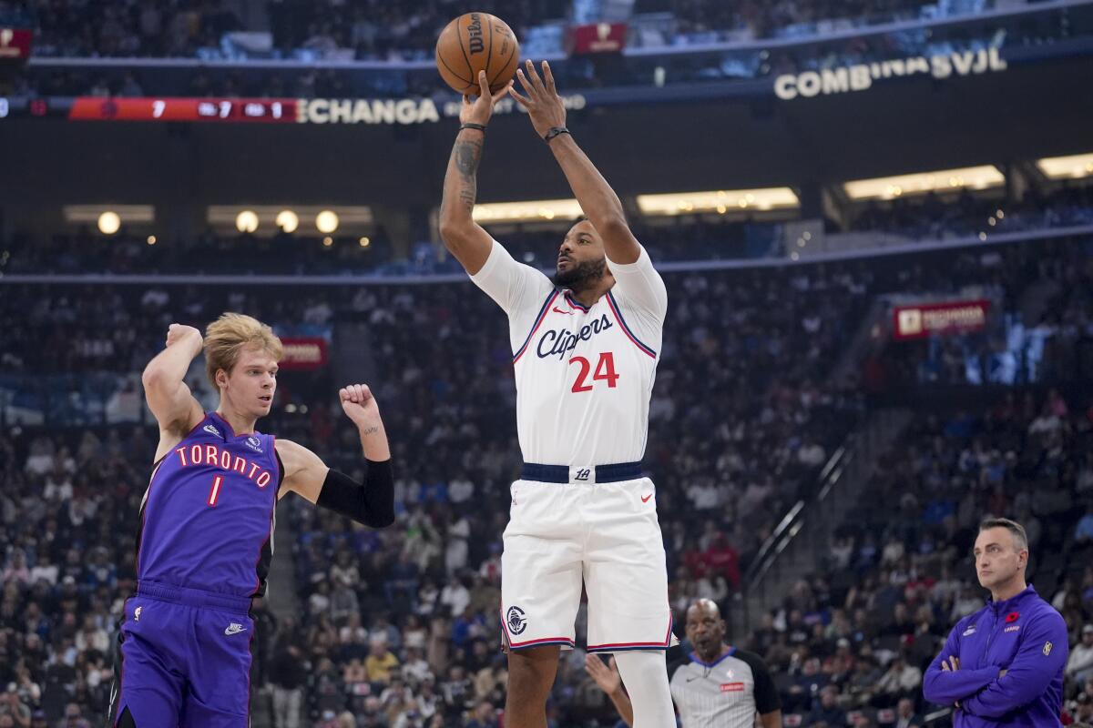 Clippers guard Norman Powell shoots over Toronto Raptors guard Gradey Dick at the Intuit Dome.