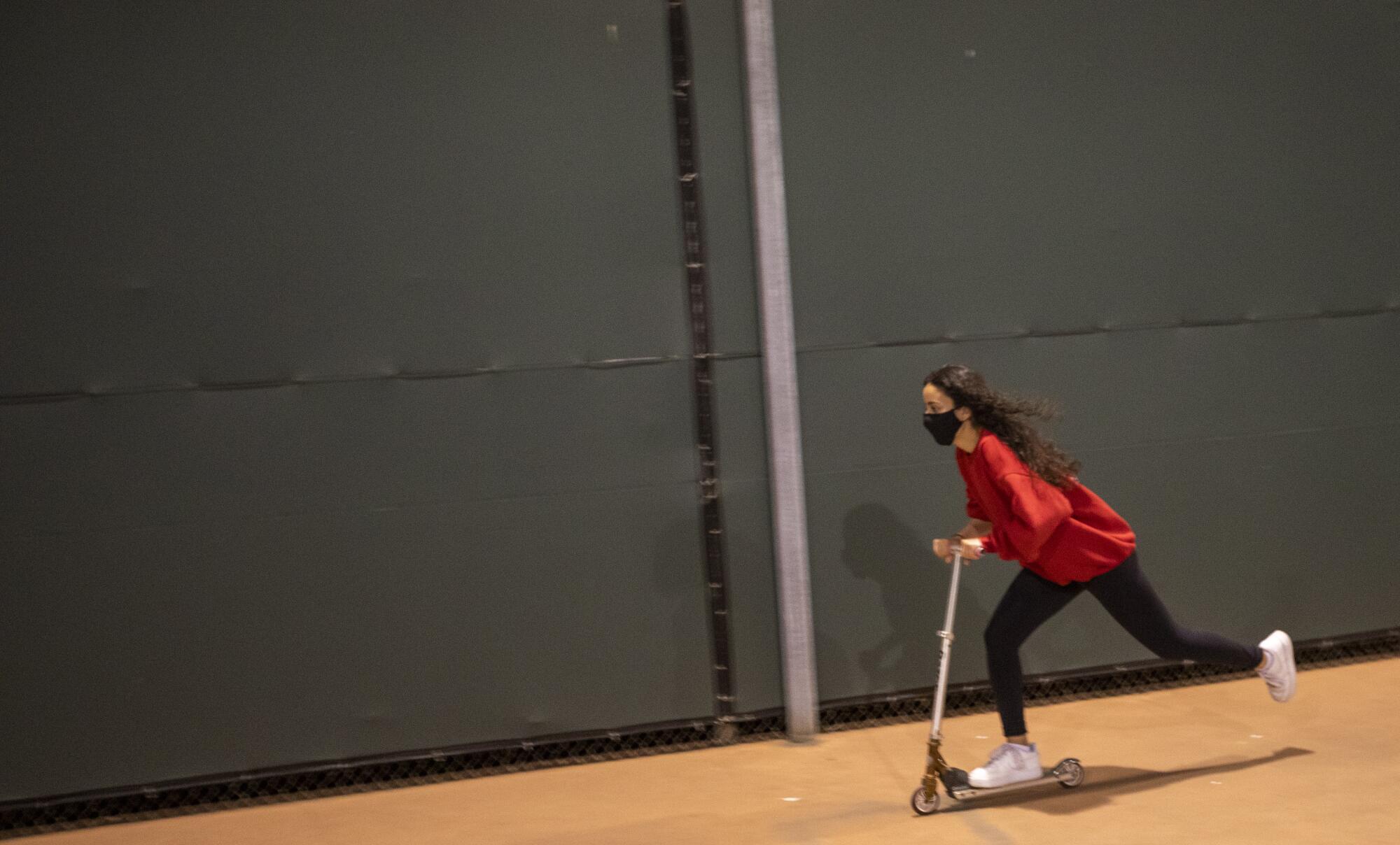 Alya Mehrtash rides a scooter