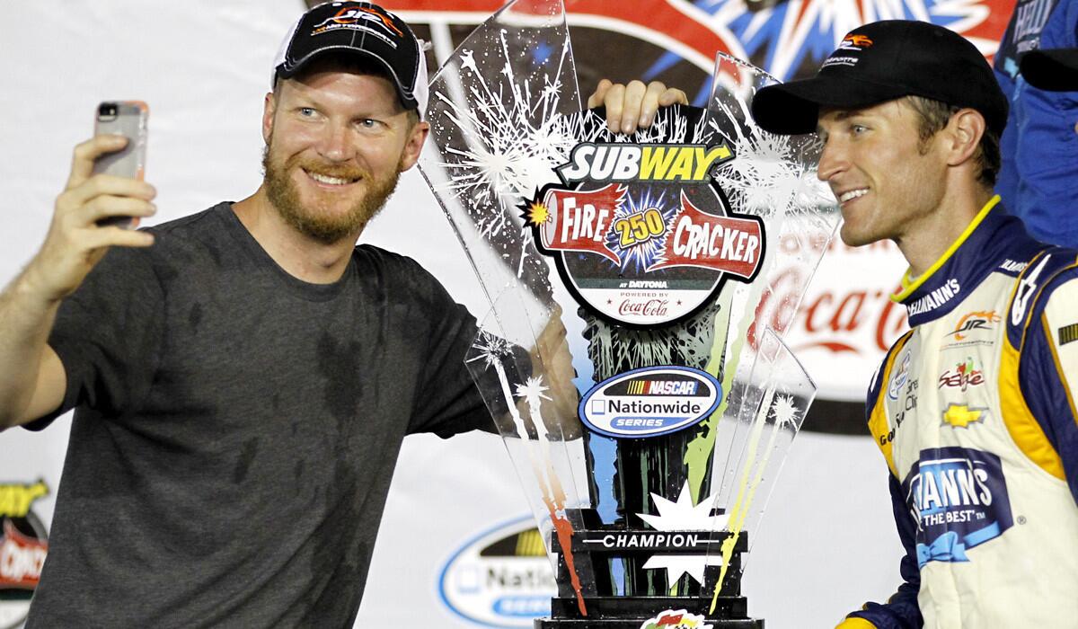 NASCAR driver Dale Earnhardt Jr., left, takes a photo with Nationwide Series race winner Kasey Kahne at Daytona International Speedway on Friday night.
