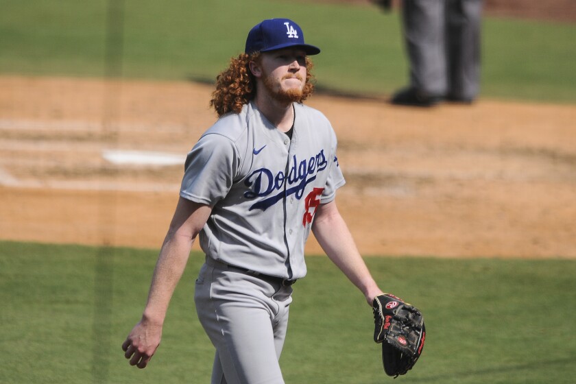 Dodgers pitcher Dustin May walks back to the dugout.
