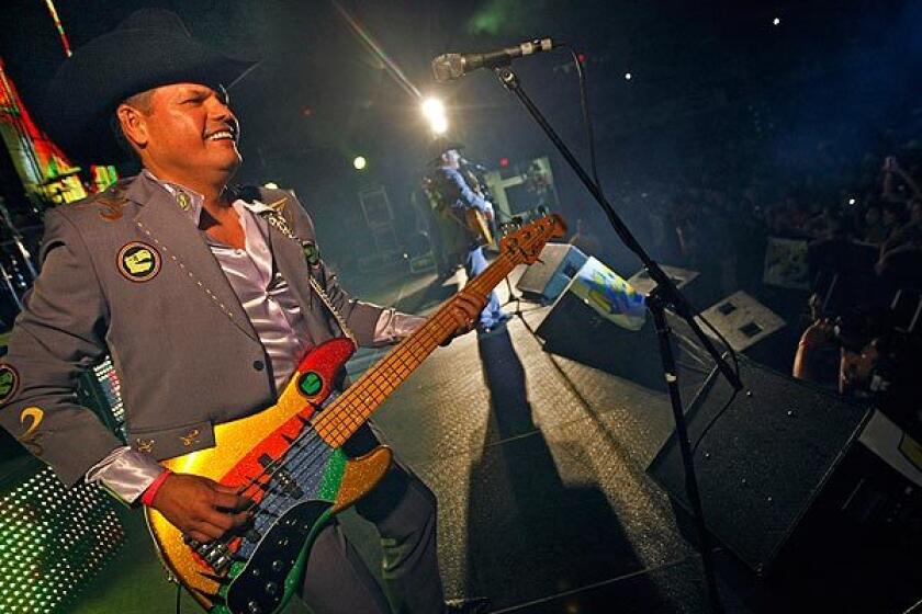 Mario Moreno Quintero, electric bass player for Los Tucanes de Tijuana, smiles at fans during a concert in San Diego. Police have forbidden the band to play in Tijuana, alleging that its songs glorify drug kingpins.