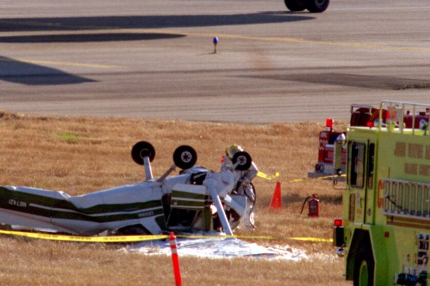 ME.Crash.152.0623.CCJohn Wayne AirportA 757 taxis by a Cessna 152 that had crashed on the grass between runways at John Wayne Airport. Early reports say, the pilot was killed in the crash and was the on board the plane.Mandatory Credit: Christine Cotter/The LA Times