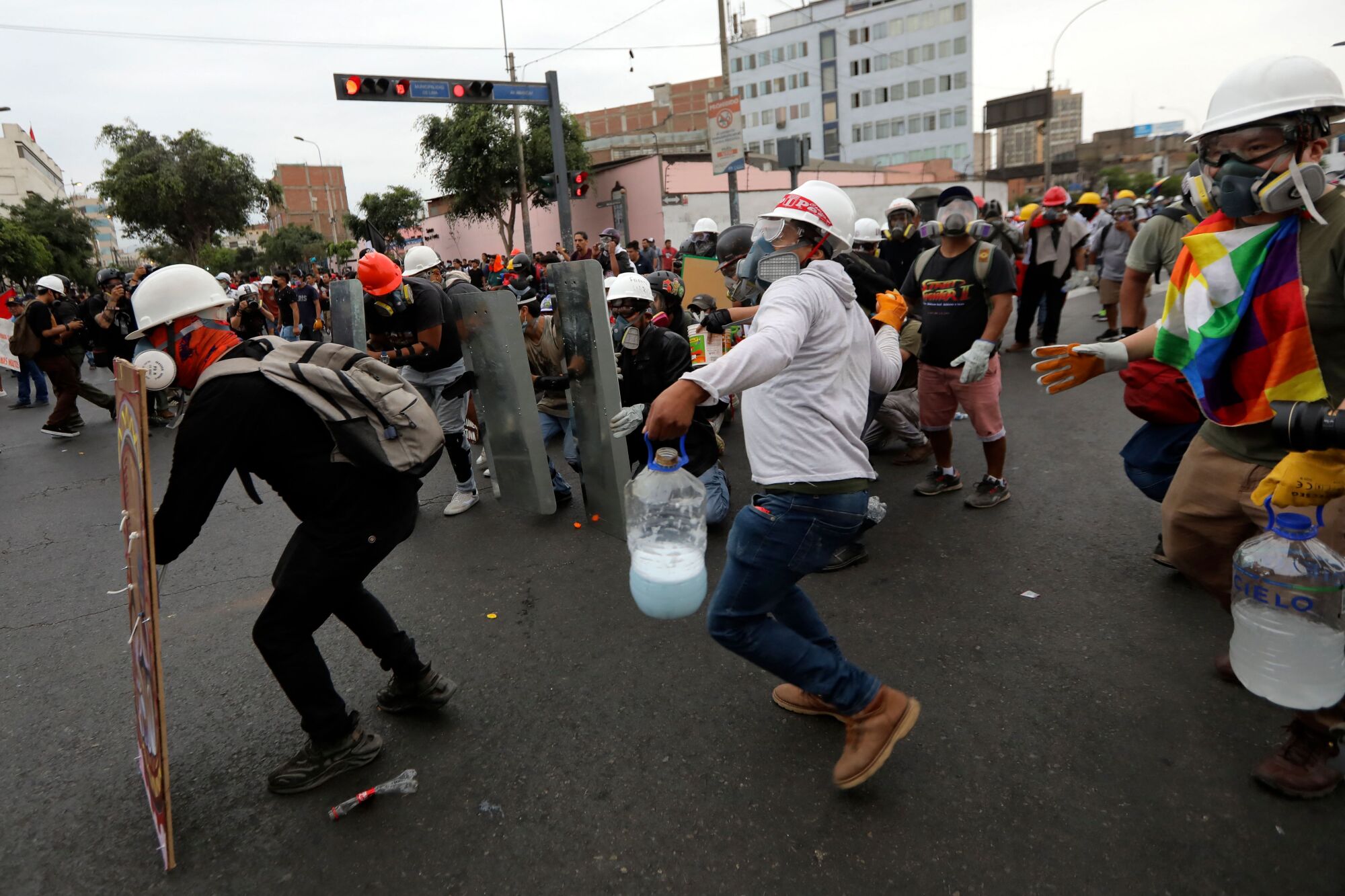 Demonstrators clash with riot police during a protest in Lima.