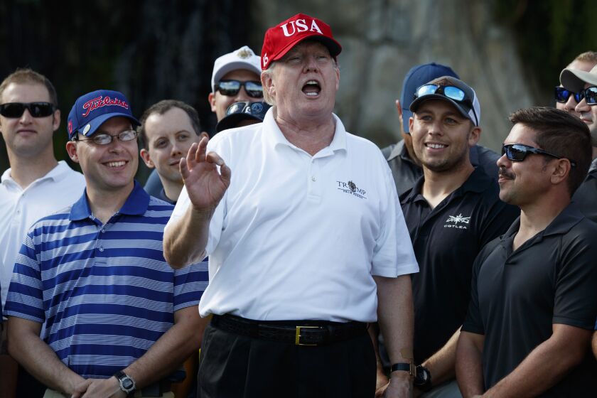President Trump speaks as he meets with members of the U.S. Coast Guard, who he invited to play golf, at Trump International Golf Club, Friday, Dec. 29, 2017, in West Palm Beach, Fla.