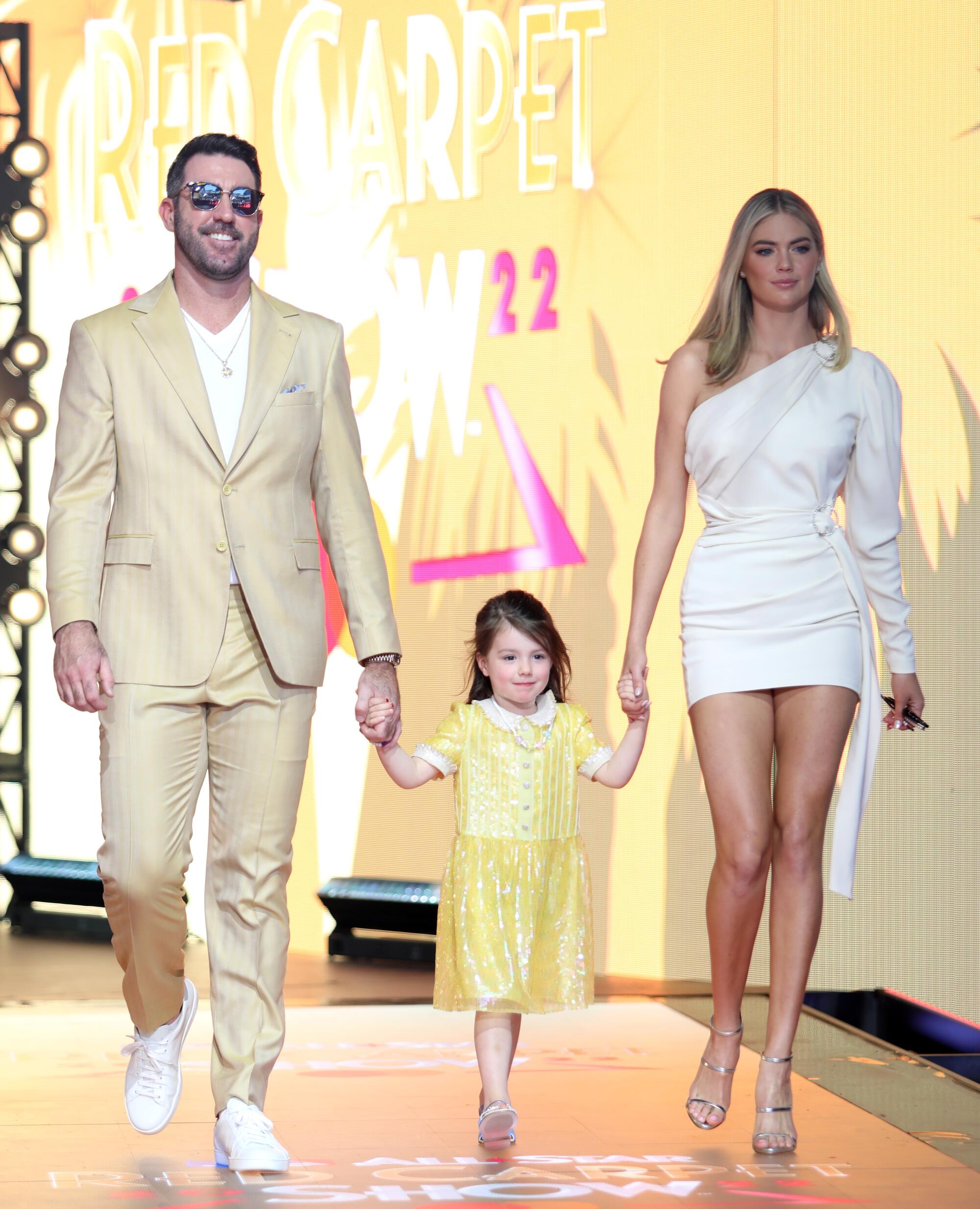 Justin Verlander in a yellow suit, Kate Upton and their daughter arrive at the 2022 MLB All-Star Game Red Carpet Show.