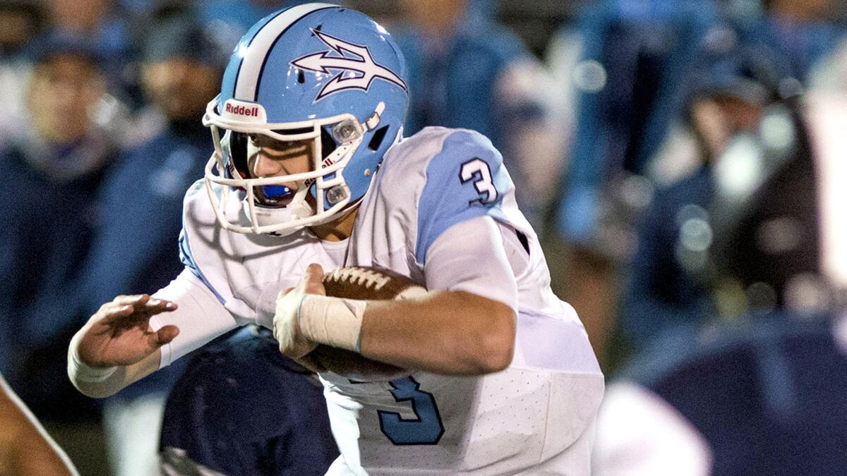 Corona del Mar quarterback Chase Garbers is held to a short gain by Sierra Canyon during the Division 4 championship game Friday night.