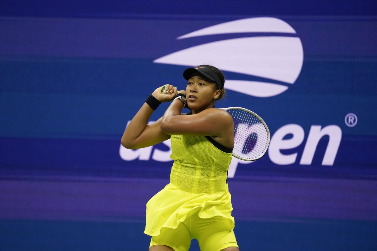 Naomi Osaka returns a shot to Leylah Fernandez during the third round of the U.S. Open on Sept. 3, 2021.