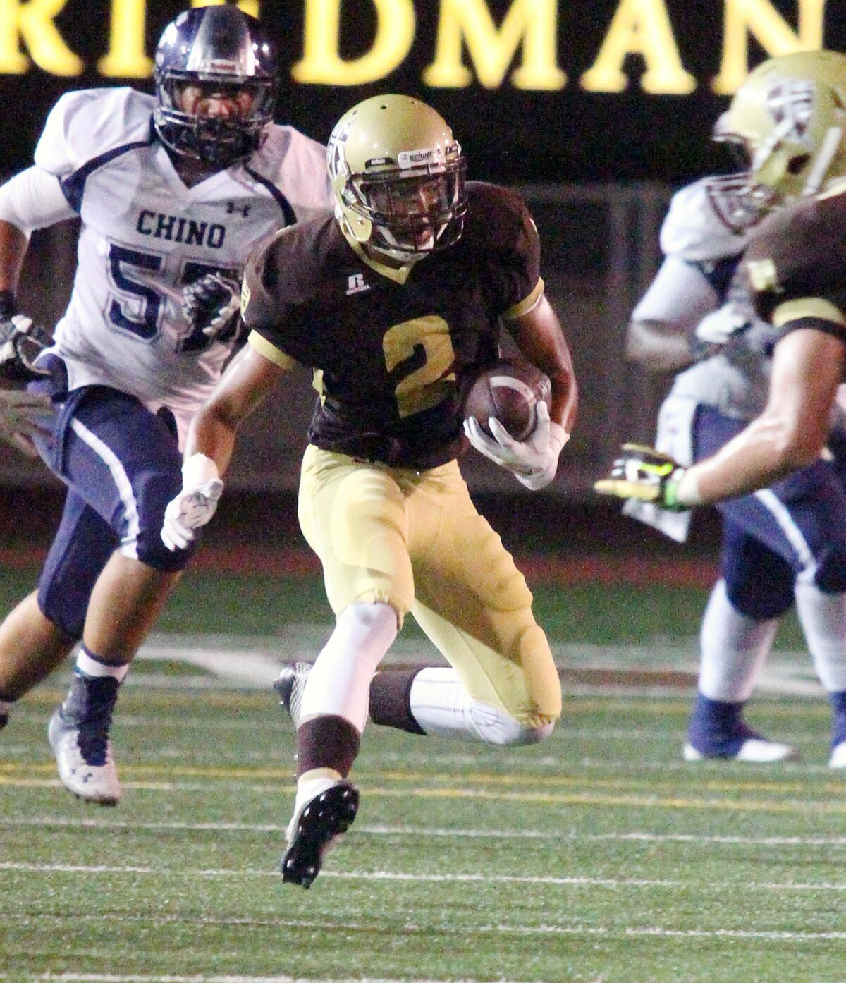 St. Francis' Dylan Crawford carries the ball after a reception in the second half against Chino in a non-league football game at St. Francis High School on Friday, September 5, 2014.