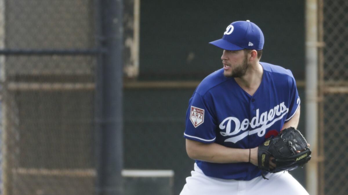 Dodgers' Clayton Kershaw makes a play during a spring training workout on Feb. 13 in Glendale, Ariz.