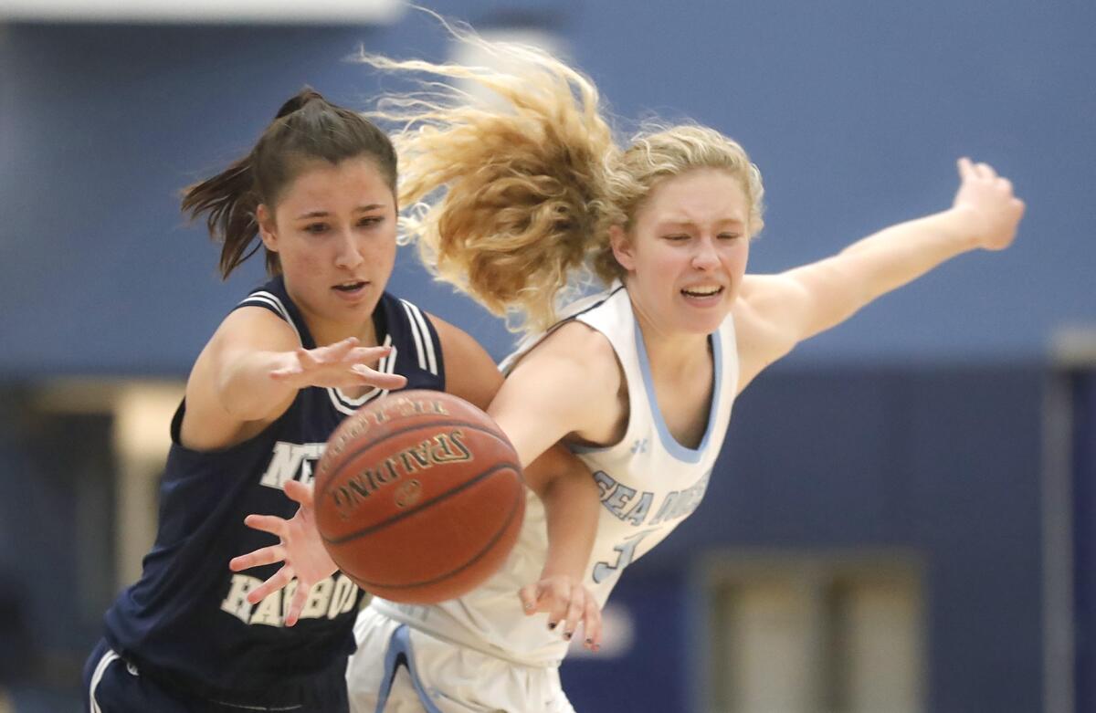 Newport Harbor's Daelyn Renee, left, steals the ball from CdM's Haley Esquino during the Battle of the Bay game.