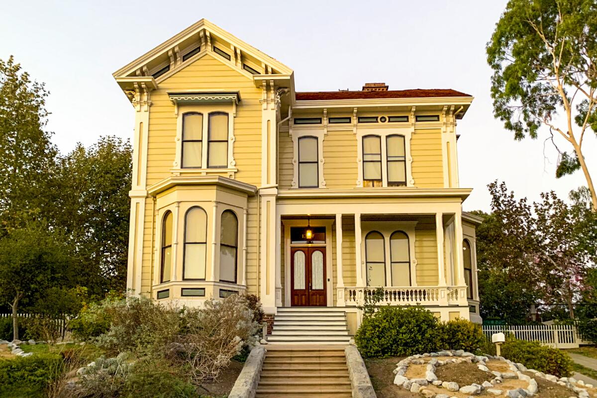 An ornate yellow Victorian home. 