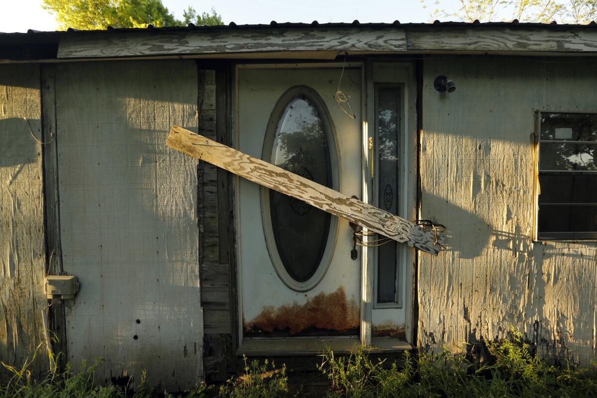 A boarded up home on the Isle of Jean Charles. (Carolyn Cole / Los Angeles Times)