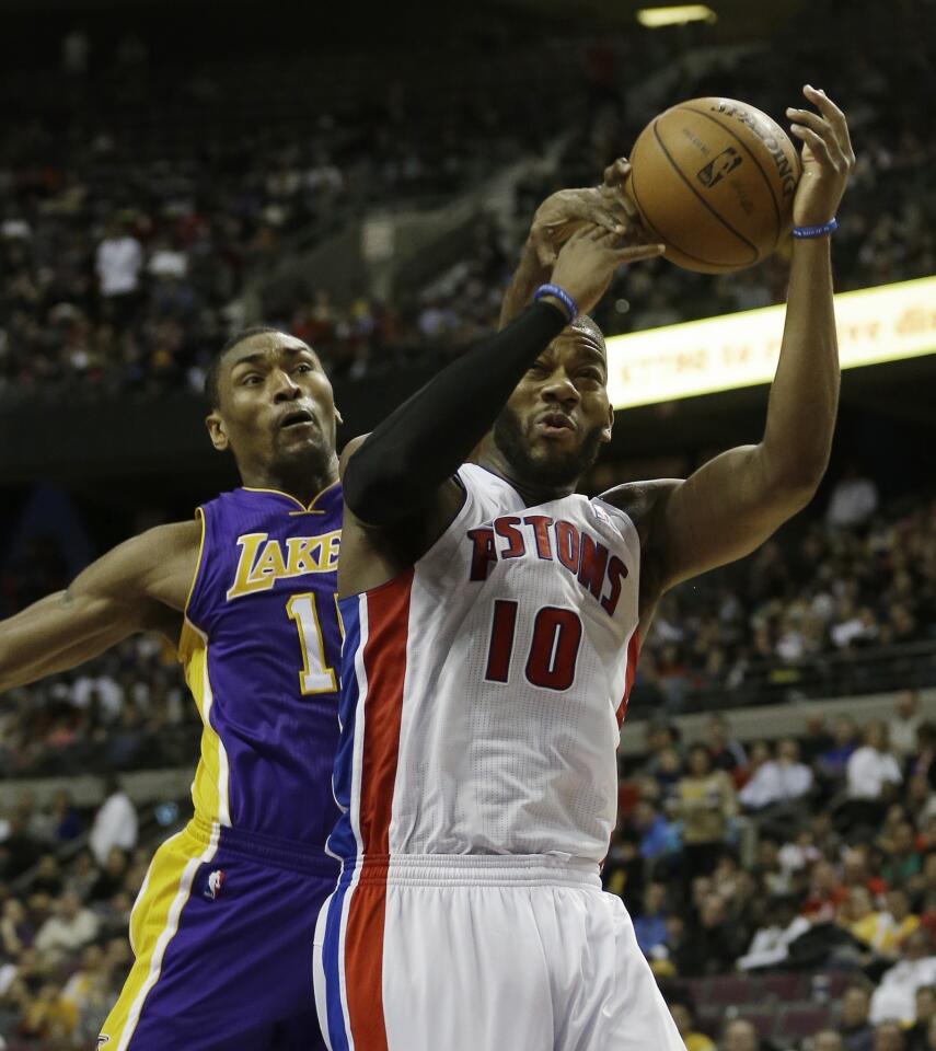 Lakers forward Metta world Peace knocks the ball from Piston center Greg Monroe in the second half Sunday.