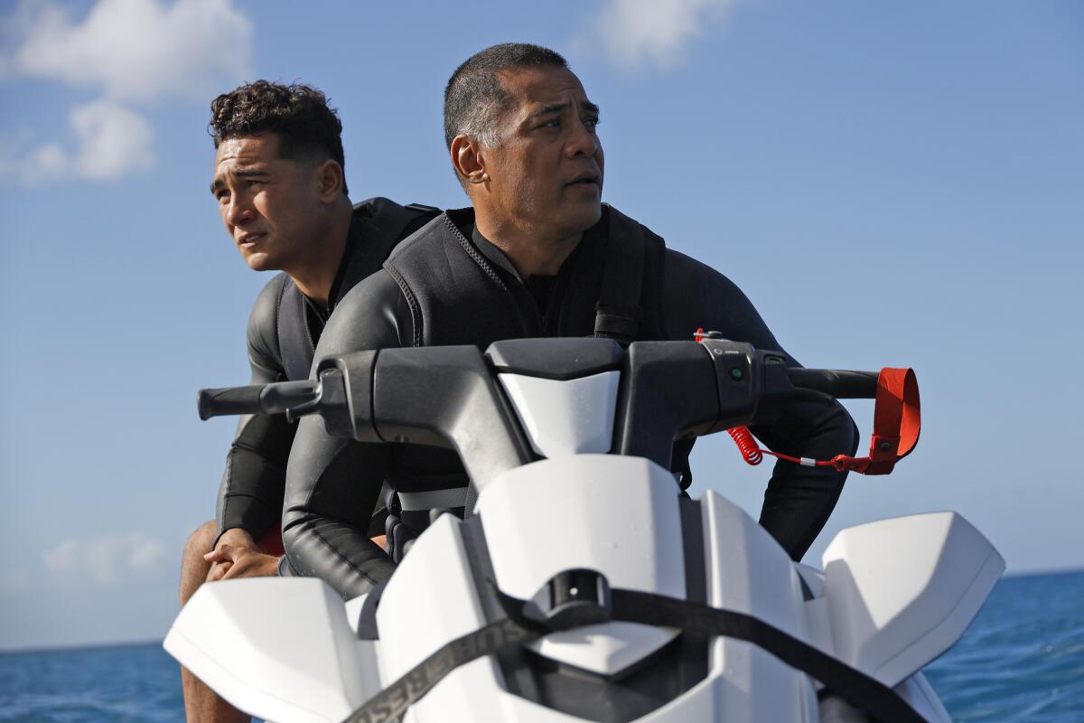 Two men on a jet-ski. 