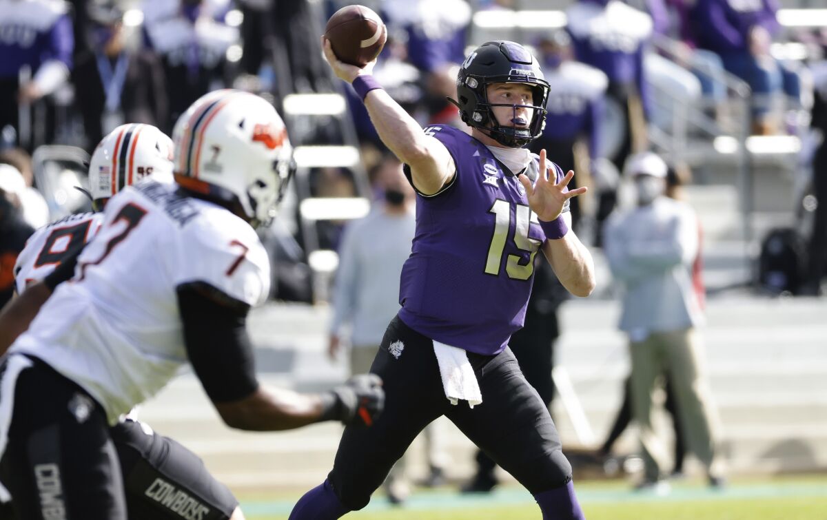 TCU quarterback Max Duggan (15) throws downfield against Oklahoma State during the first half of an NCAA college football game Saturday, Dec. 5, 2020, in Fort Worth, Texas. (AP Photo/Ron Jenkins)