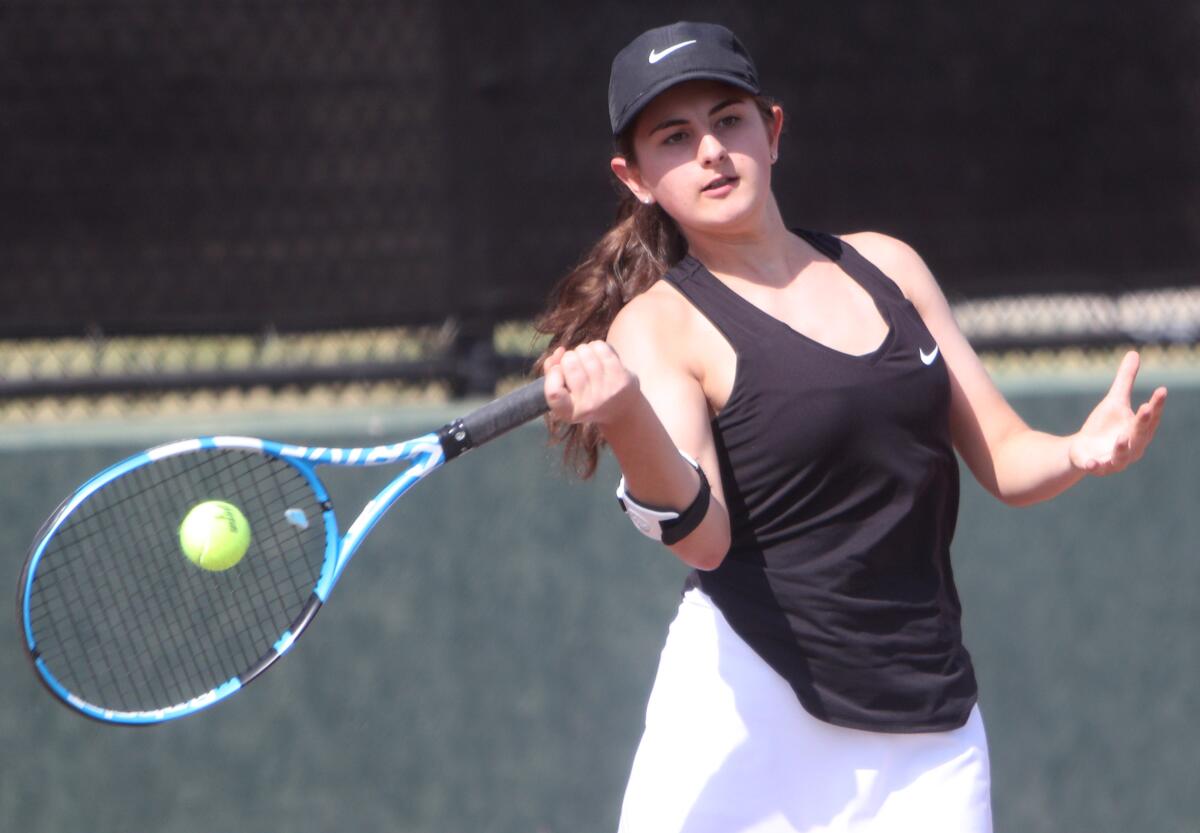 Glendale High singles player Celine Khachiki returns a serve in a match at Burroughs on Thursday.