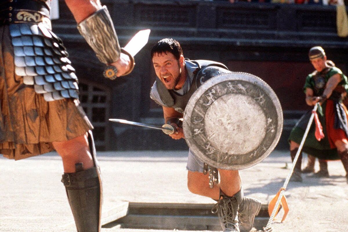 Russell Crowe yells while about to swing a sword in a scene from "Gladiator."