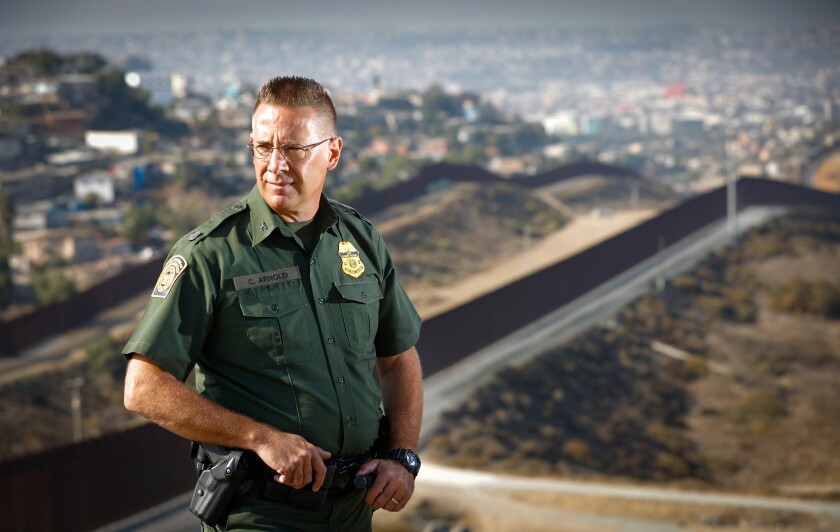 Chancy Arnold, assistant patrol chief of the U.S. Border Patrol's San Diego sector, is also the longest serving Border Patrol agent in the United States. He is photographed at "Arnie's Point," with the border fence and Tijuana’s Colonia Libertad in the background.