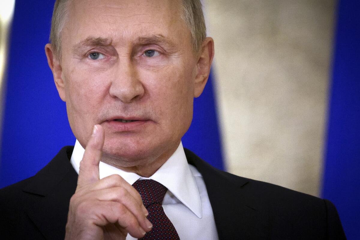 Russian President Vladimir Putin gestures as he speaks.