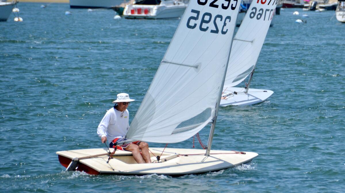 Sailing his Laser, Big Jim, Seymour Beek, 88, competes in Flight of Newport Beach sailboat race on Sunday.