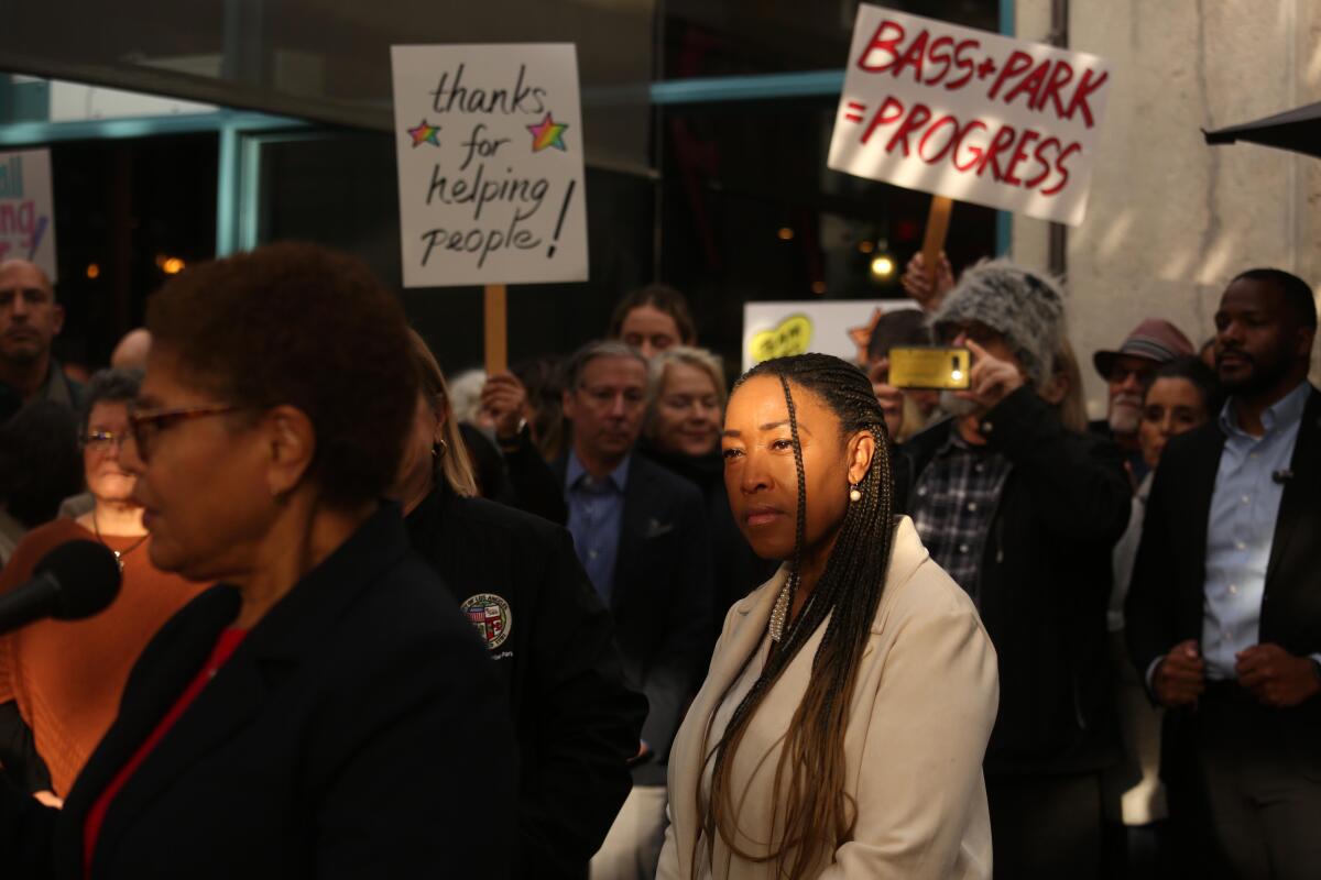 A woman in a crowd of people, some with signs