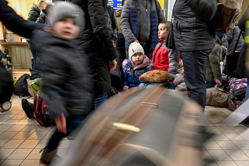 Refugees from Ukraine gather at the main train station in Przemysl, Poland on Sunday. 