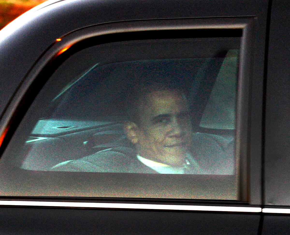 President Barack Obama looks out the window of his presidential limousine while en route to NBC studios for an appearance on the Tonight Show with Jay Leno in this 2012 file photo.