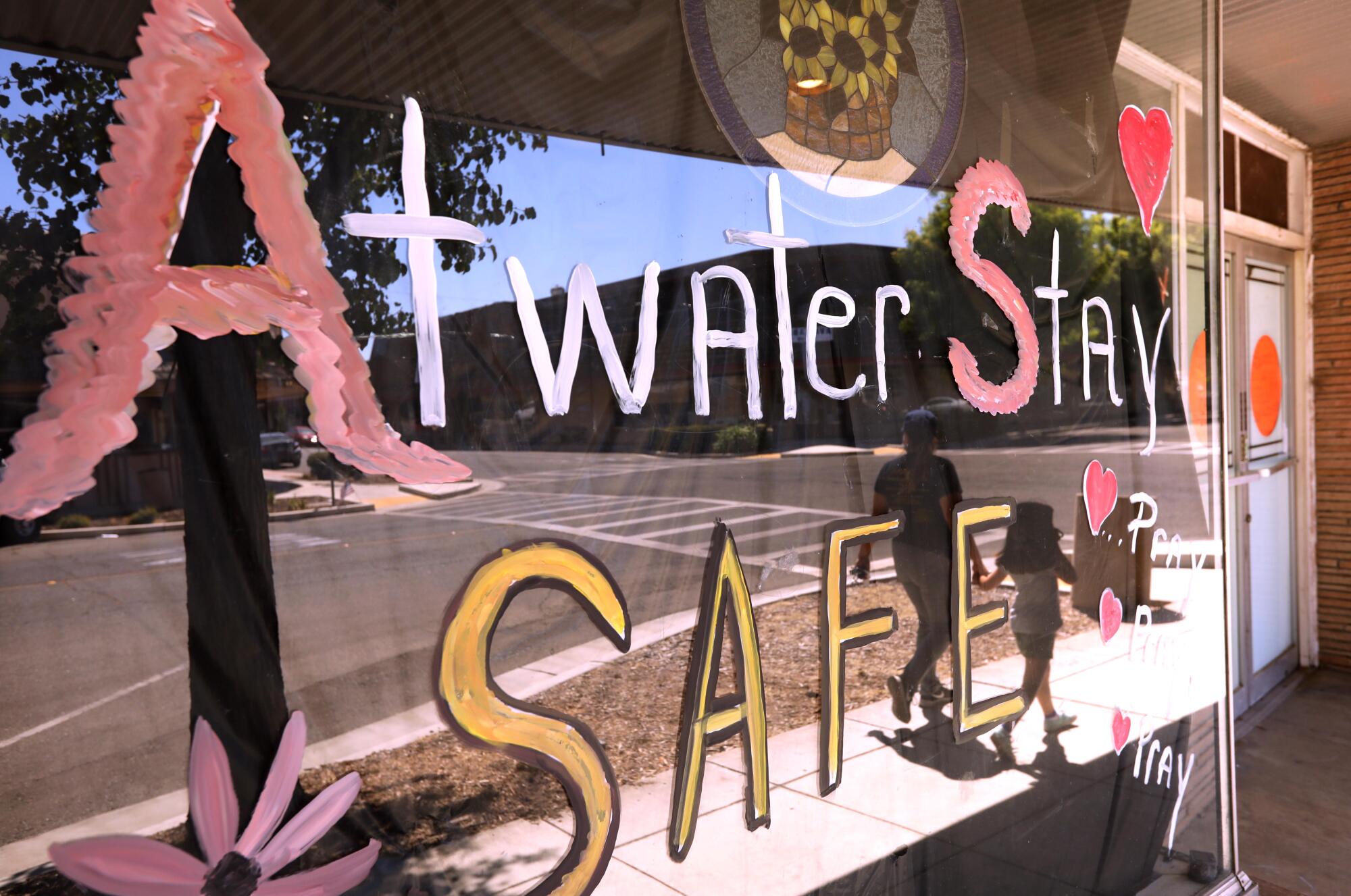 A sign on a closed storefront window makes a statement to residents regarding the pandemic in Atwater.